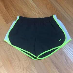 Grey and yellow Nike running shorts.